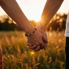 Couple holding hands wearing bracelet